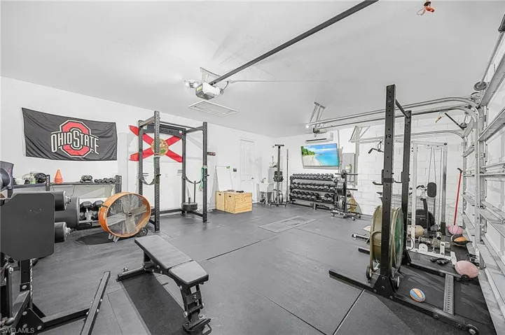 Oversized 3-car garage featuring an 18,000 BTU smart mini-split heating and cooling system—perfect for a workshop, gym, or climate-controlled storage.  Easy setup for a fun Airbnb game room with AC already in place.  Clean and ready for you!