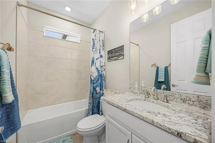 Third full bathroom with modern finishes, ideal for guests or convenient access from multiple areas of the home.  Easy access just around the corner from the sliders out to the pool.