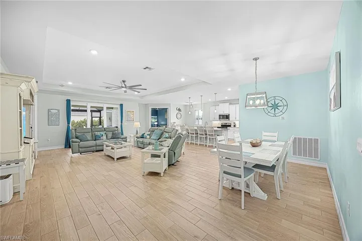 Open-concept living area designed for modern Florida living, offering seamless flow between the kitchen, dining, and living spaces—perfect for entertaining or everyday comfort.