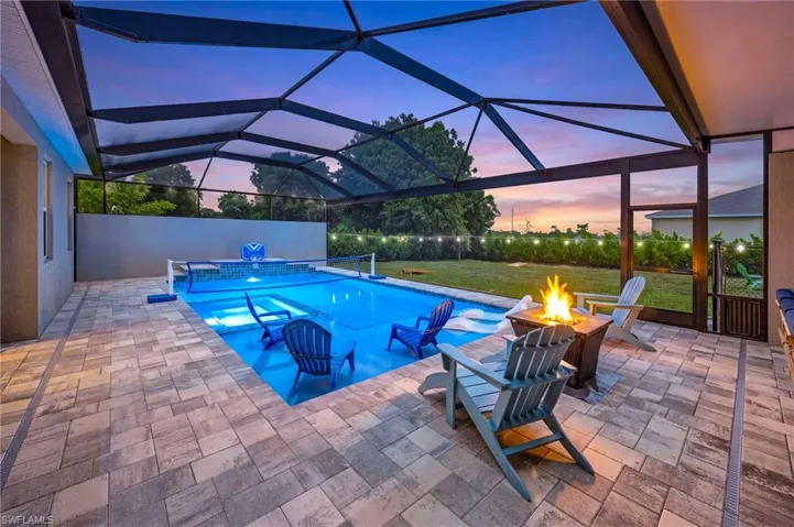 Resort-style outdoor living begins here, showcasing one of the most impressive backyard setups in Northwest Cape Coral.  Pool and spa illuminated for unforgettable Florida evenings, creating a stunning nighttime ambiance perfect for entertaining.