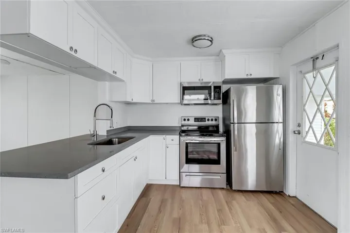 Bright Kitchen with Stainless Steel Appliances & White Shaker Cabinets