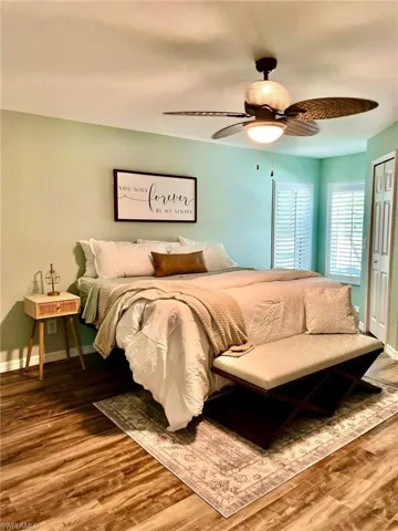 Bedroom with a closet, wood-type flooring, and ceiling fan