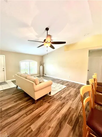 Living room featuring ceiling fan and hardwood / wood-style floors