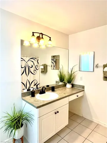 Bathroom featuring tile floors and large vanity