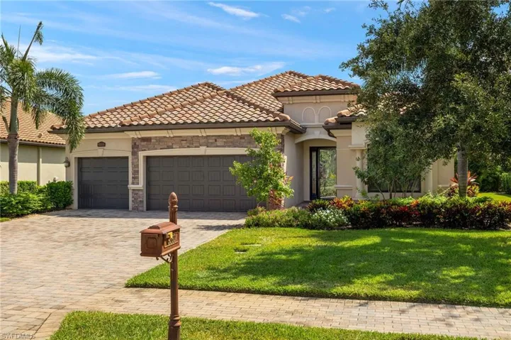 Mediterranean / spanish-style home featuring a front yard and a garage