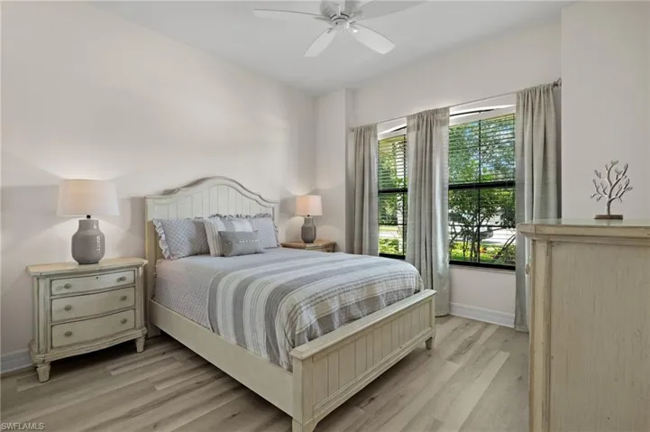 Bedroom with ceiling fan and light hardwood / wood-style flooring