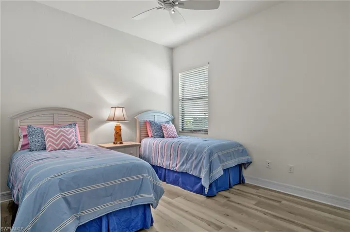 Bedroom featuring ceiling fan and light hardwood / wood-style flooring