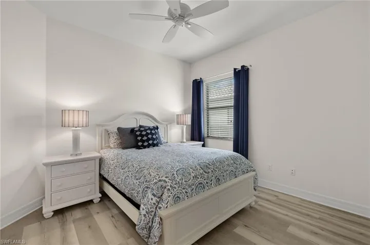 Bedroom featuring ceiling fan and light hardwood / wood-style flooring