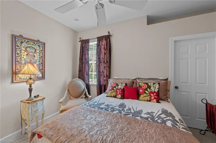 Carpeted bedroom with baseboards and ceiling fan