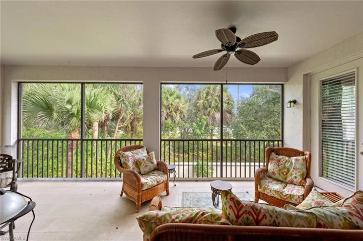 Sunroom / solarium with tile patterned flooring and a textured wall