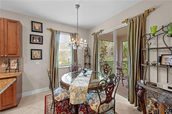 Dining room featuring light tile patterned flooring and a chandelier