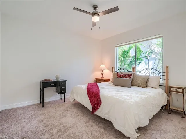 Carpeted bedroom with ceiling fan
