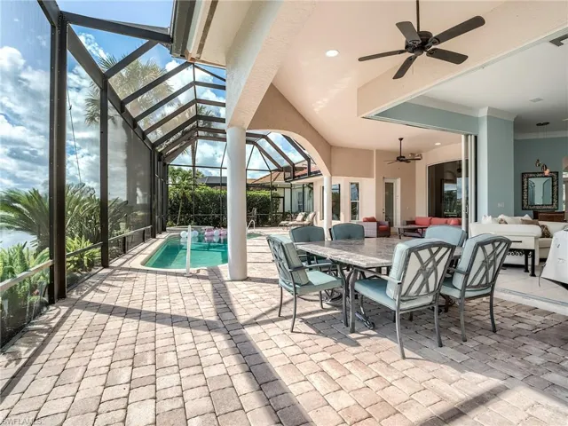 View of swimming pool featuring a lanai, ceiling fan, and a patio area