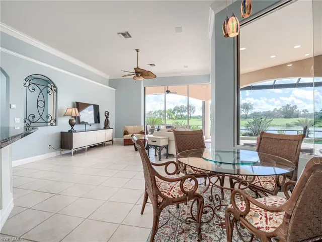 Tiled dining space with ornamental molding and a wealth of natural light