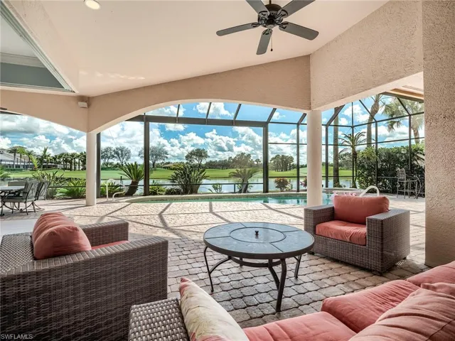 Sunroom featuring ceiling fan, lofted ceiling, and a water view