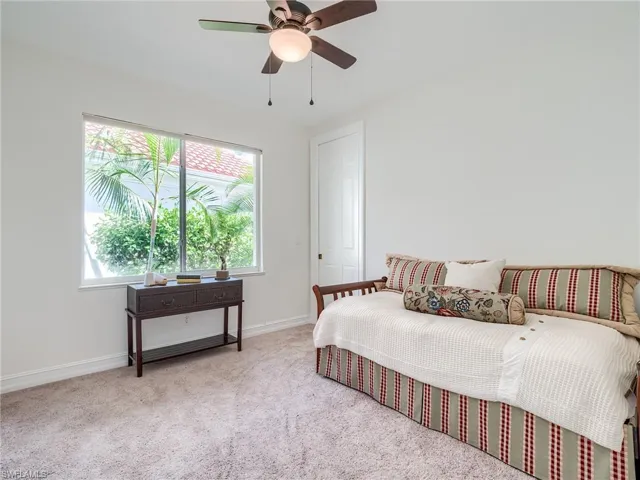 Carpeted bedroom with ceiling fan