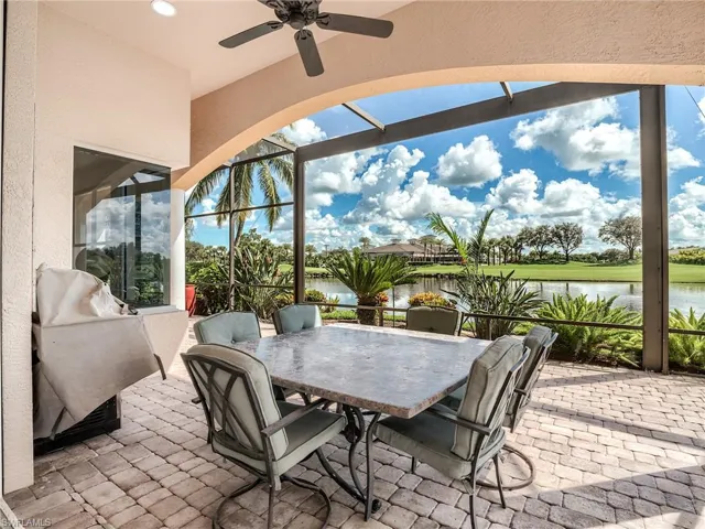 View of patio / terrace featuring a water view, ceiling fan, and screened enclosure