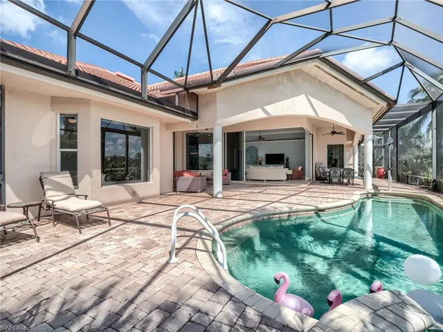 View of pool featuring ceiling fan, an outdoor hangout area, screened enclosure, and a patio