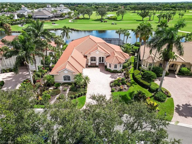 Birds eye view of property with a water view