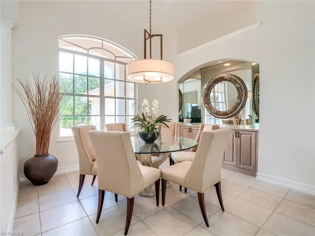 Dining area with light tile patterned flooring