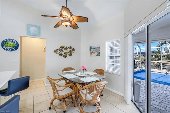 Dining room featuring light tile patterned floors, baseboards, and a ceiling fan