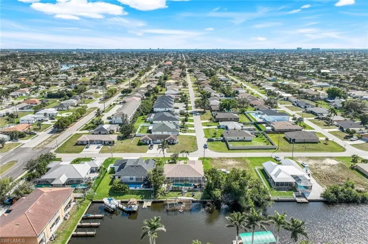 Birds eye view of property with a residential view and a water view
