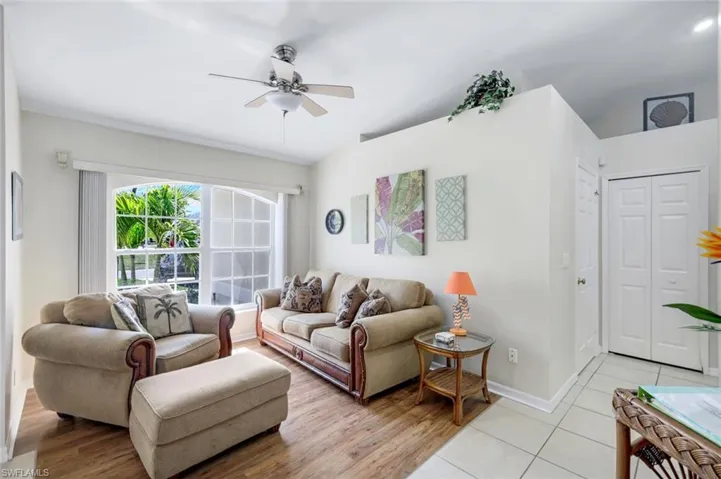 Living area featuring ceiling fan, light wood finished floors, and baseboards