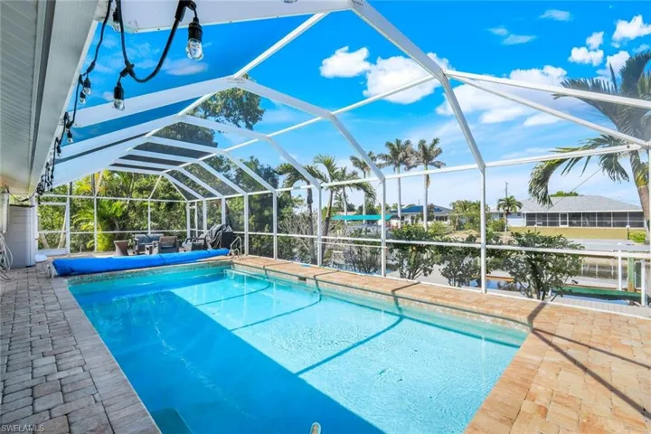 View of pool with a lanai, a covered pool, and a patio