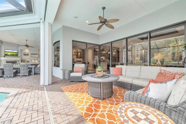 Covered lanai featuring brick paver flooring, recessed lighting, a ceiling fan, and floor-to-ceiling sliding glass doors
