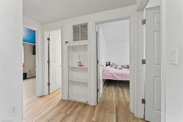 Hall with light wood-style flooring