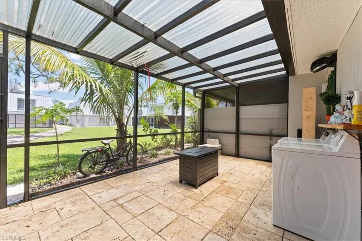 Sunroom featuring washer and dryer and healthy amount of natural light