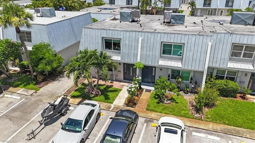 View of building exterior featuring uncovered parking