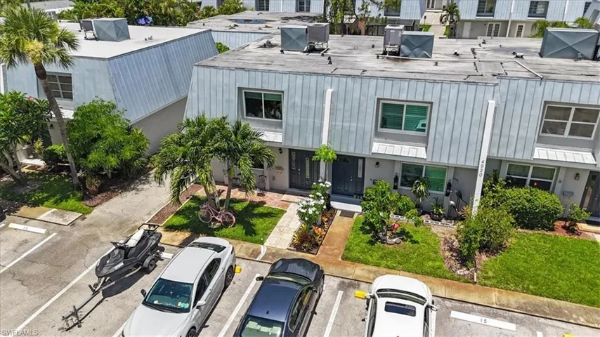 View of building exterior with uncovered parking