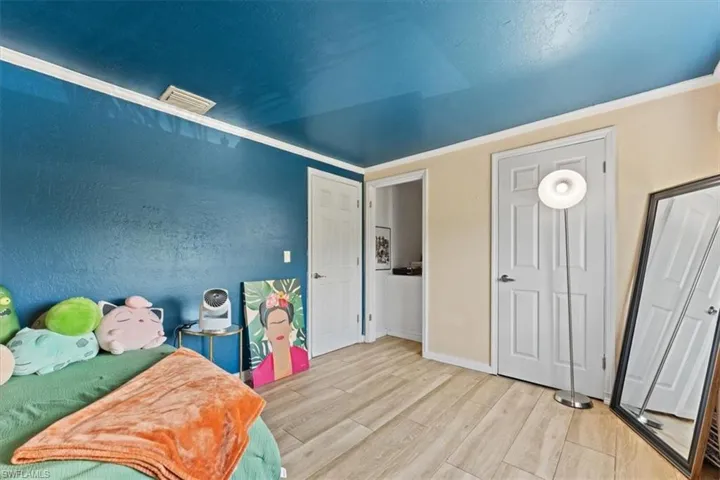 Bedroom with wood finished floors and baseboards