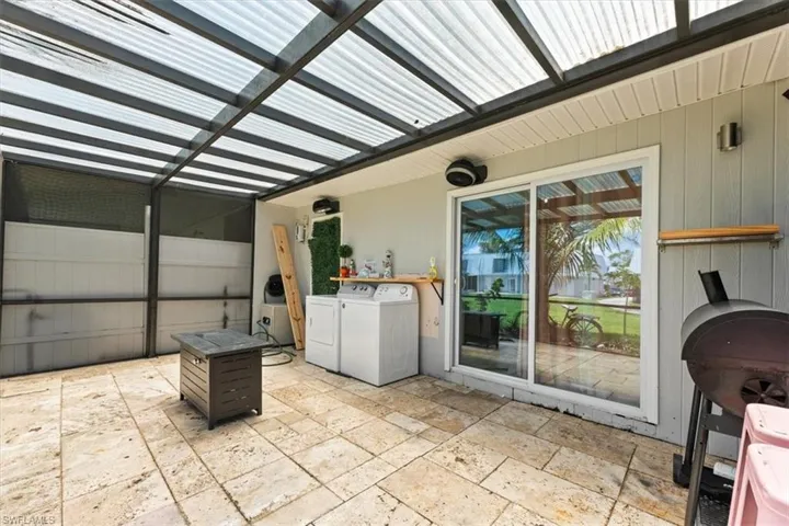 View of patio / terrace with separate washer and dryer and a grill