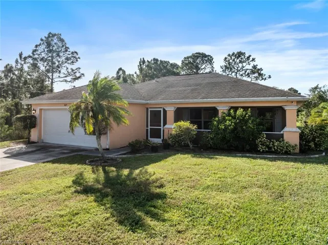 Single story home featuring a 2 car garage and a front lawn
