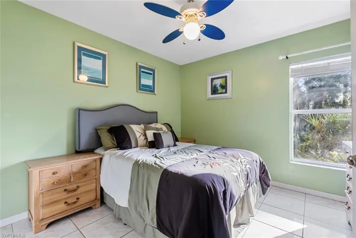 2nd Bedroom with light tile patterned flooring and ceiling fan