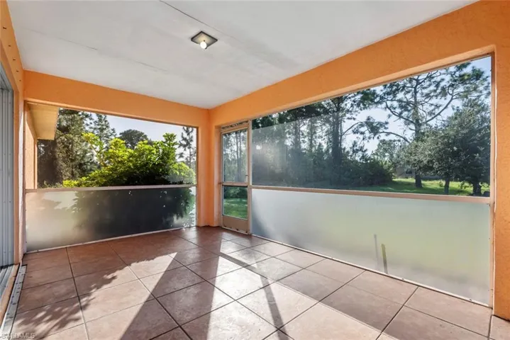 Screened lanai with door out to the large backyard