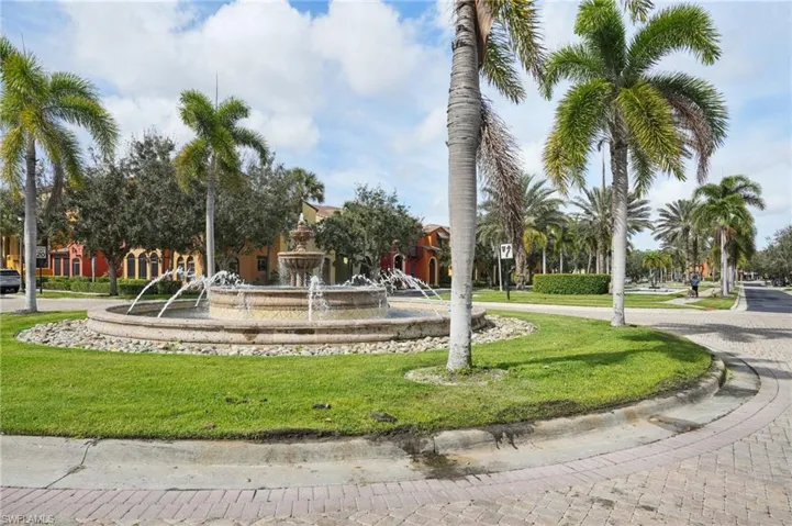 View of property's community with a lawn