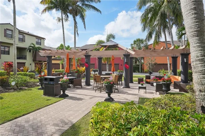 View of home's community featuring a patio area, a yard, and a pergola