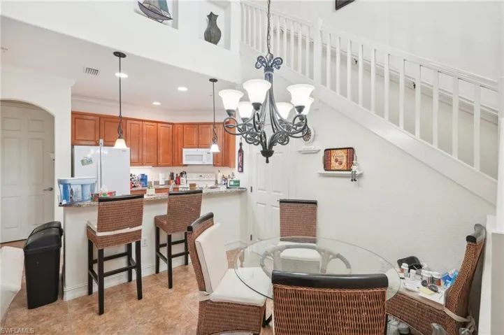 Dining area featuring visible vents, stairway, an inviting chandelier, crown molding, and recessed lighting