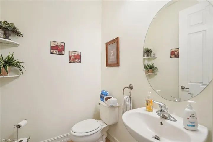 Bathroom with baseboards, a sink, and toilet