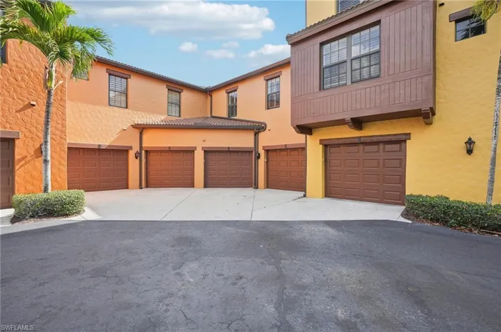View of property with driveway, an attached garage, and stucco siding