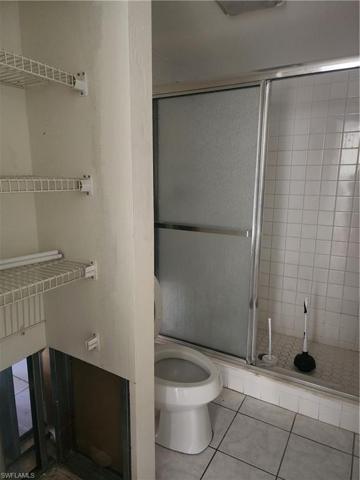 Linen Closet and Walk-in Shower in Primary Bathroom