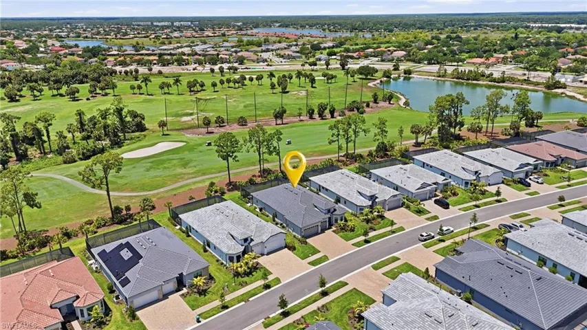 Aerial perspective highlighting a single-story residence with a paved driveway and an attached two-car garage