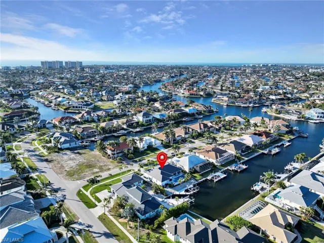 Birds eye view of property with a water view