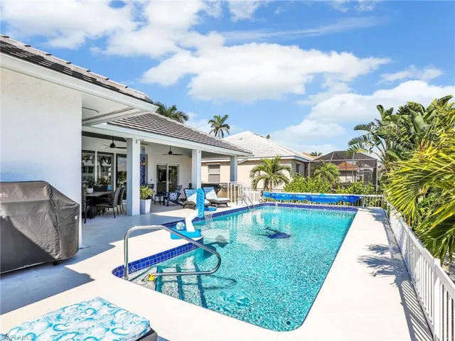 View of pool featuring a patio and ceiling fan
