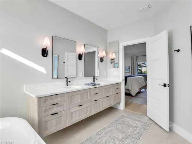 Bathroom with tile patterned floors and vanity