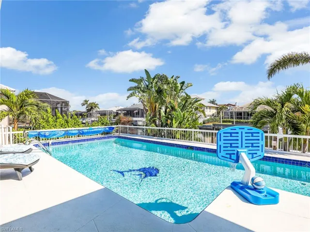 View of swimming pool with a patio and glass enclosure