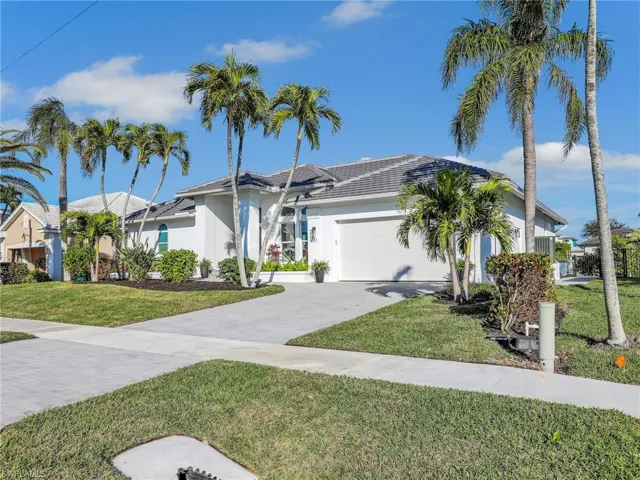 View of front facade featuring a garage and a front yard